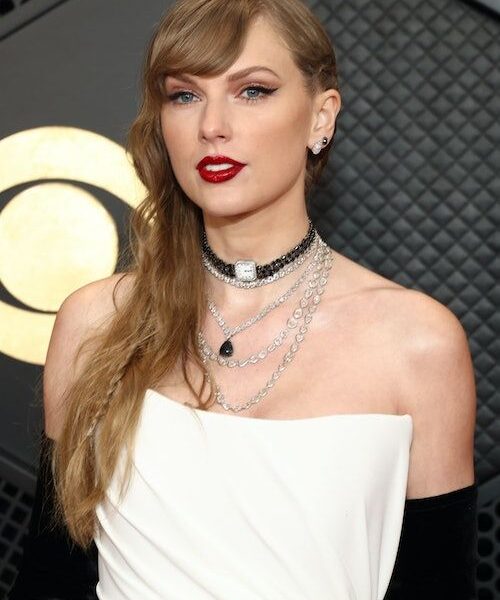Taylor Swift attended the 2024 Grammys in a white corset gown with a Reputation Easter egg.